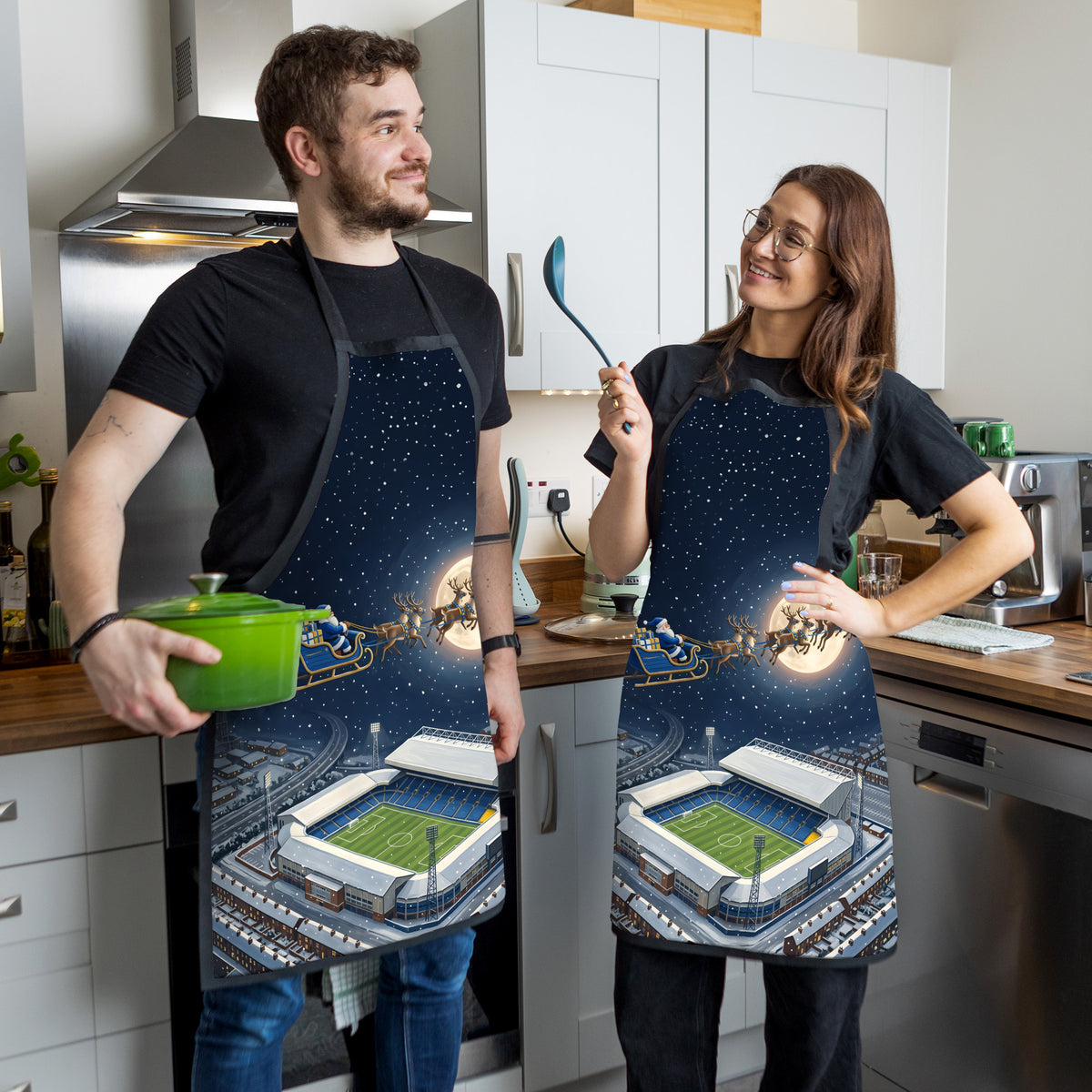 Leeds Christmas Stadium Apron - couple in kitchen